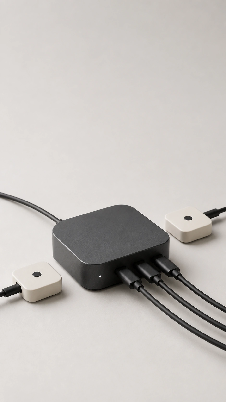Compact desk hub with connected cables on a light studio background